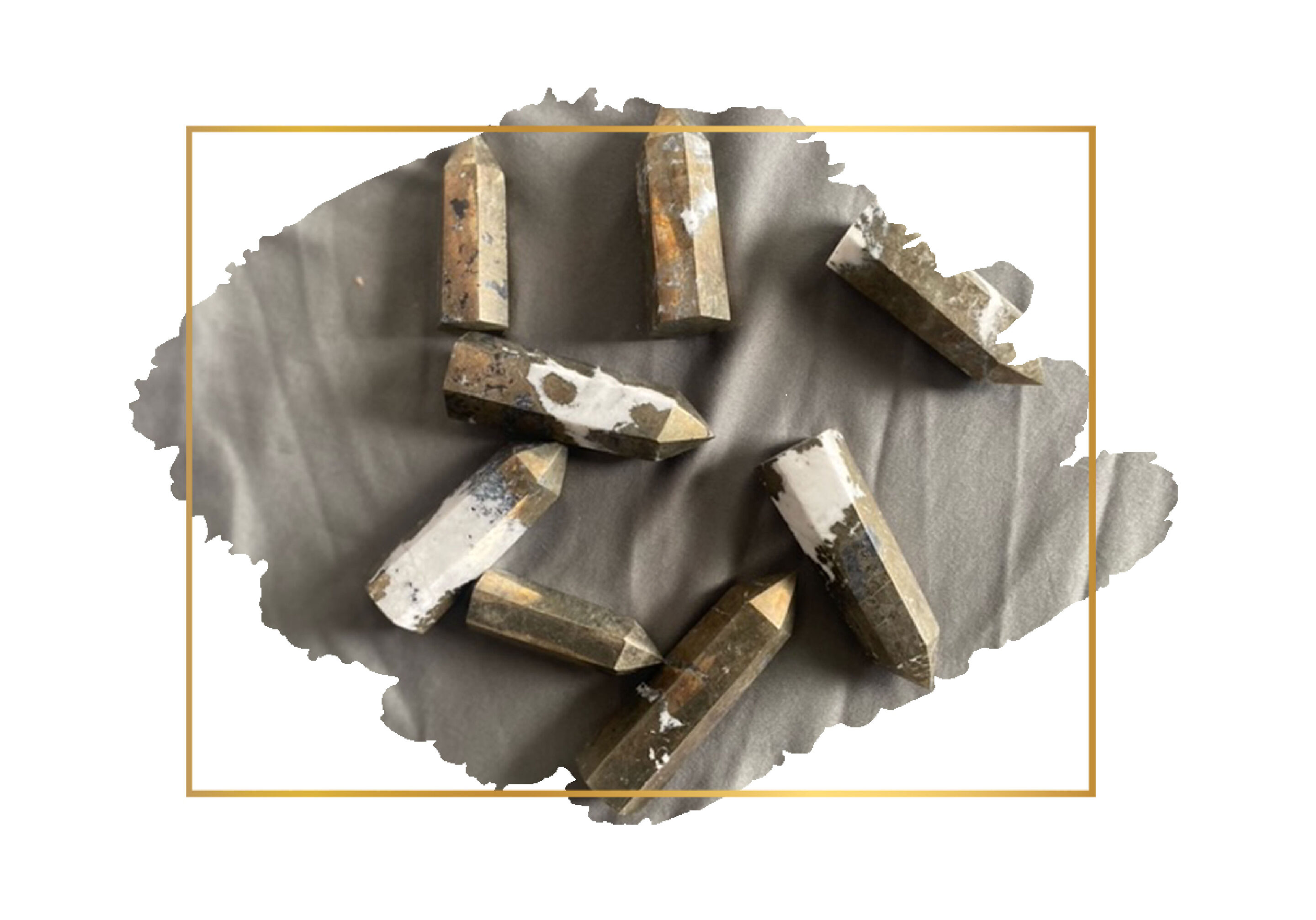 Several used graphite pencils with broken tips are scattered on a torn piece of gray paper, overlaid with part of a thin, gold rectangular border.