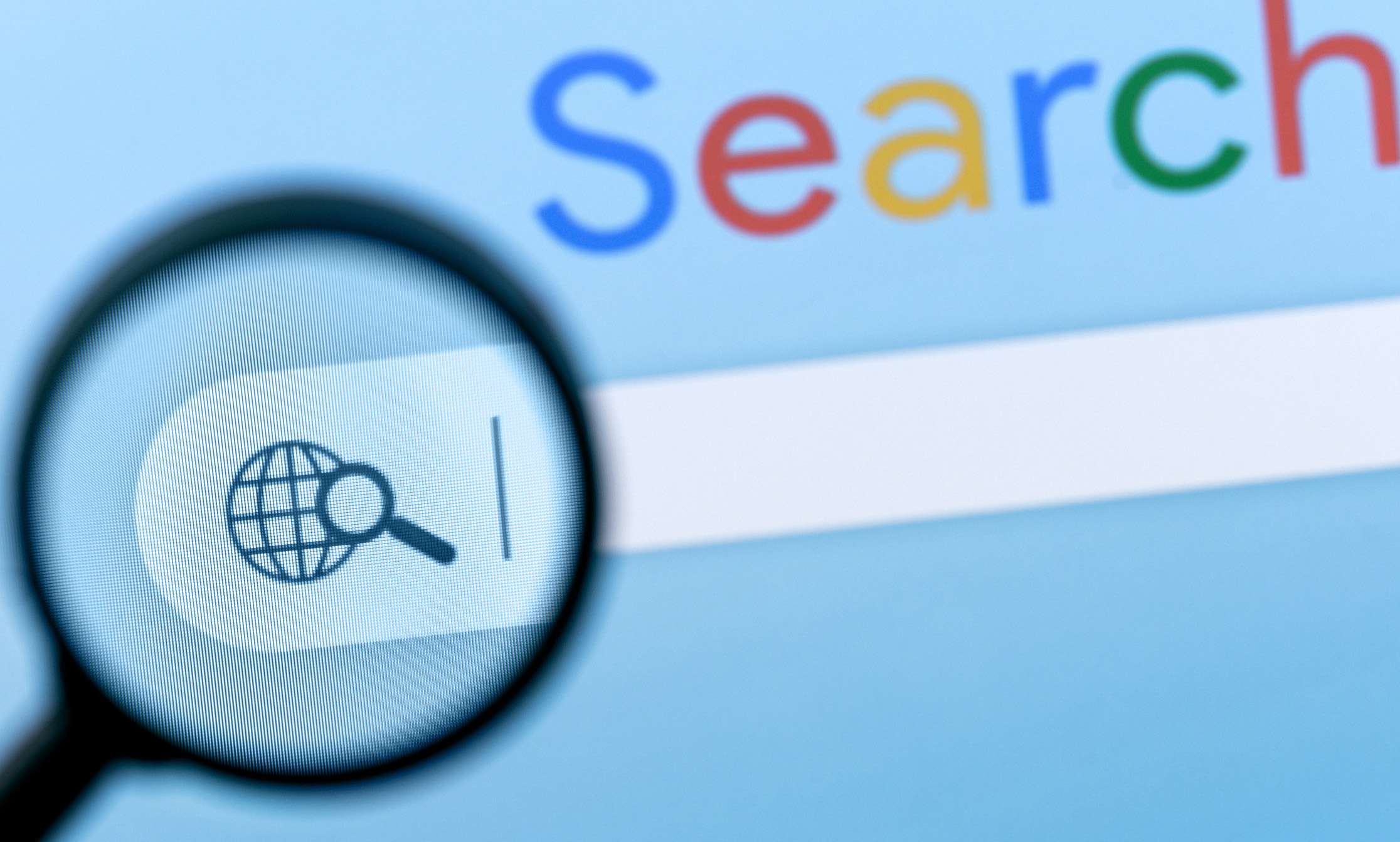 how long does seo to rank first A close-up photo of a computer screen showing a search engine homepage. A magnifying glass focuses on the search bar, where "how long does SEO take" appears beneath the globe icon, with part of the word Search visible in colorful letters above.